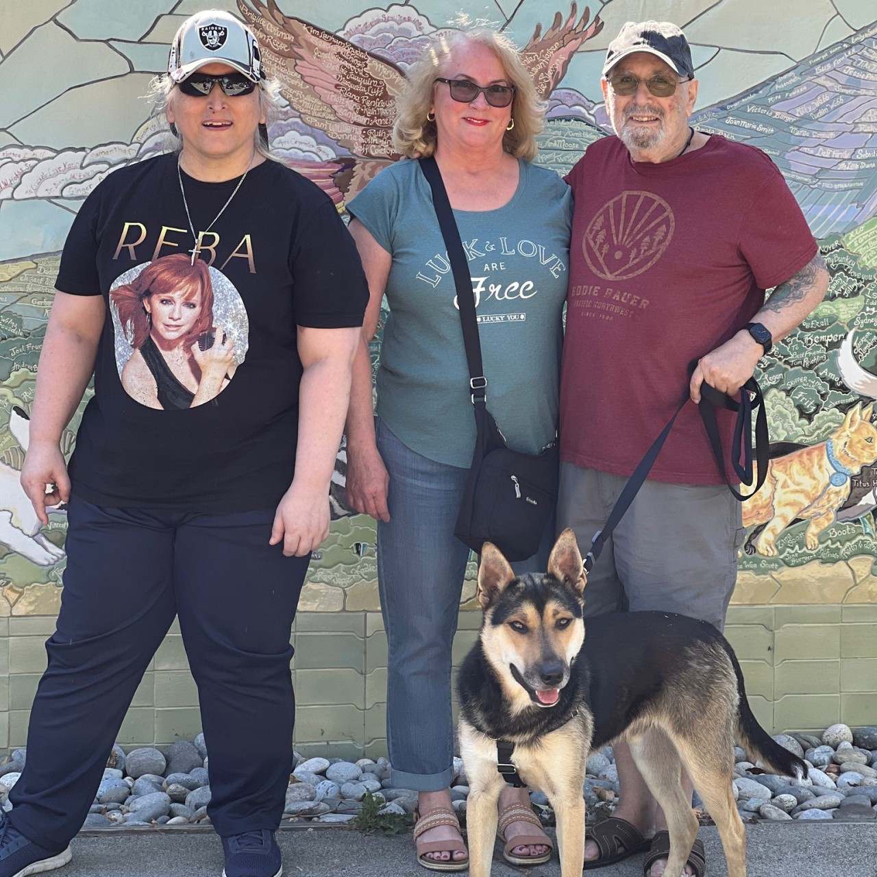 Three people with the dog they adopted from Marin Humane