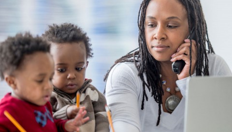 Mom on phone with two children